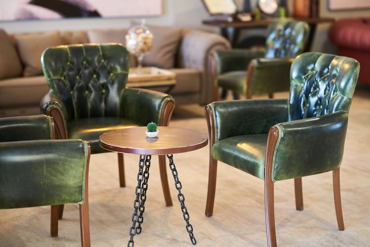 journey-01 Stylish green leather armchairs with a chic table in a contemporary room.