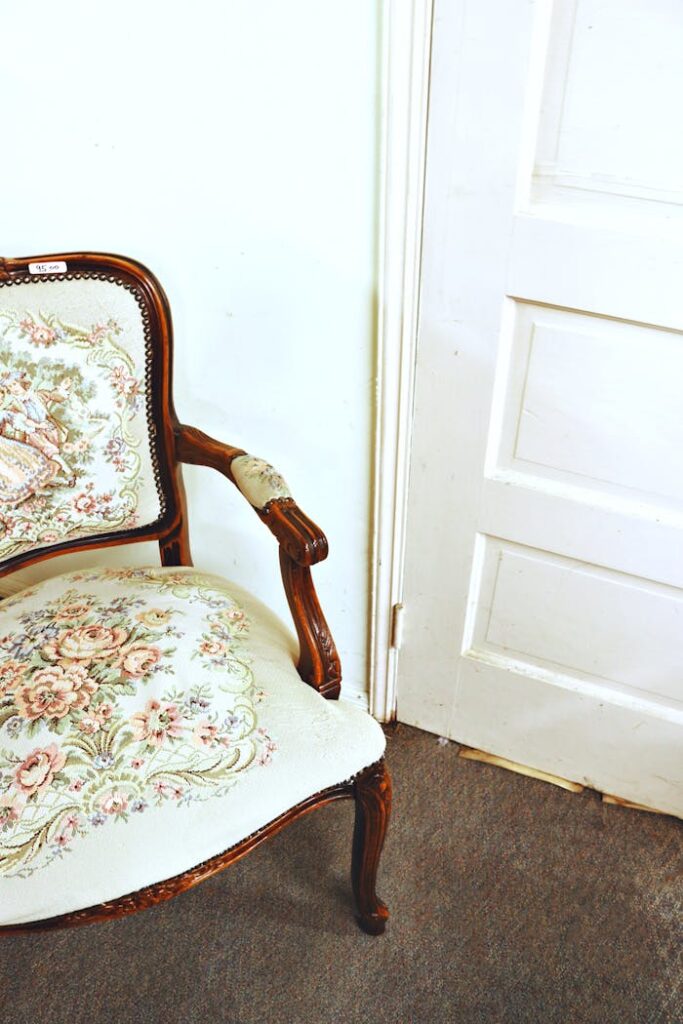 pexels photo 2894961 Elegant vintage floral armchair in home interior with wooden details and soft upholstery.